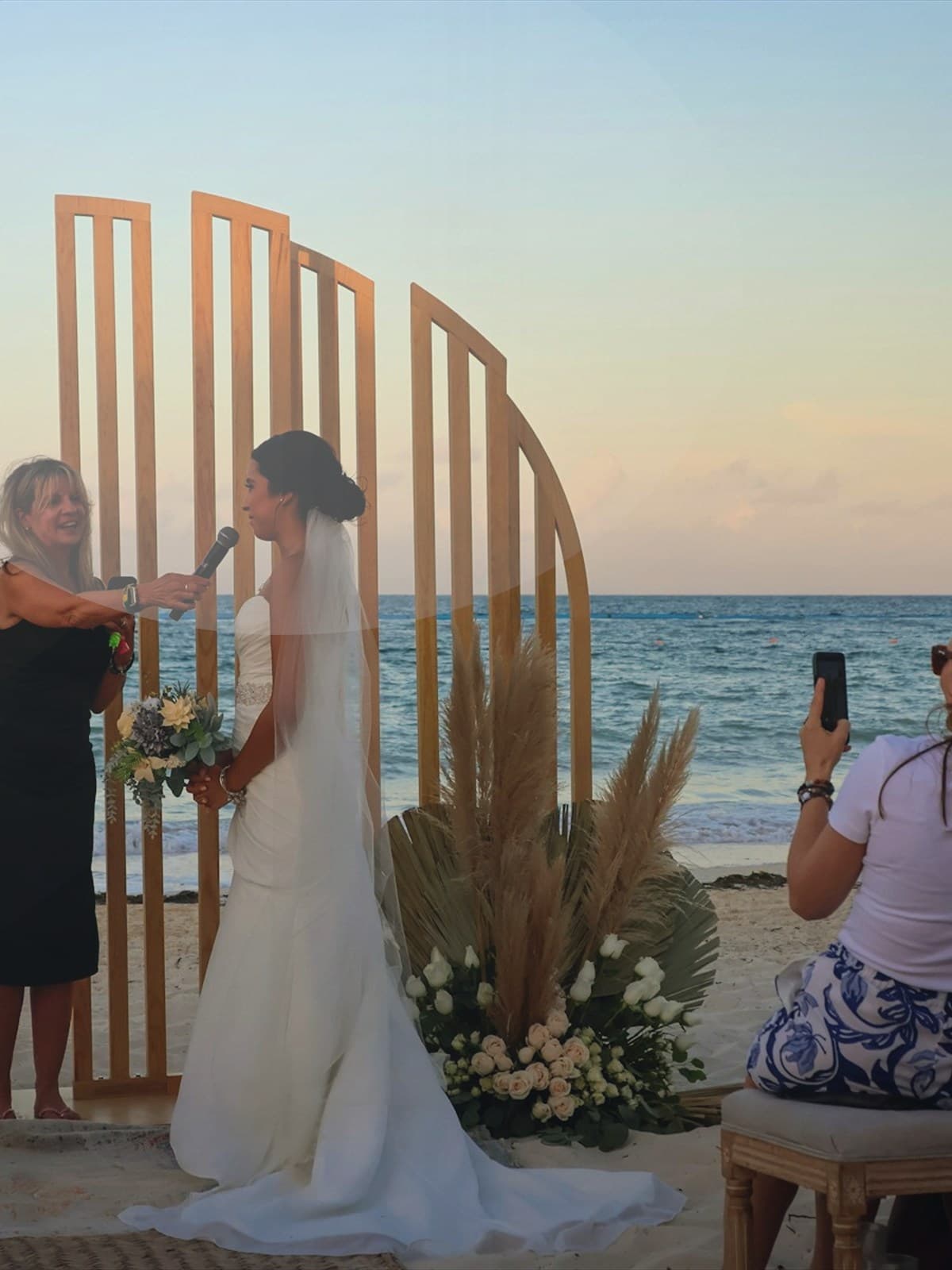 Couple embracing on a tropical beach at sunset.