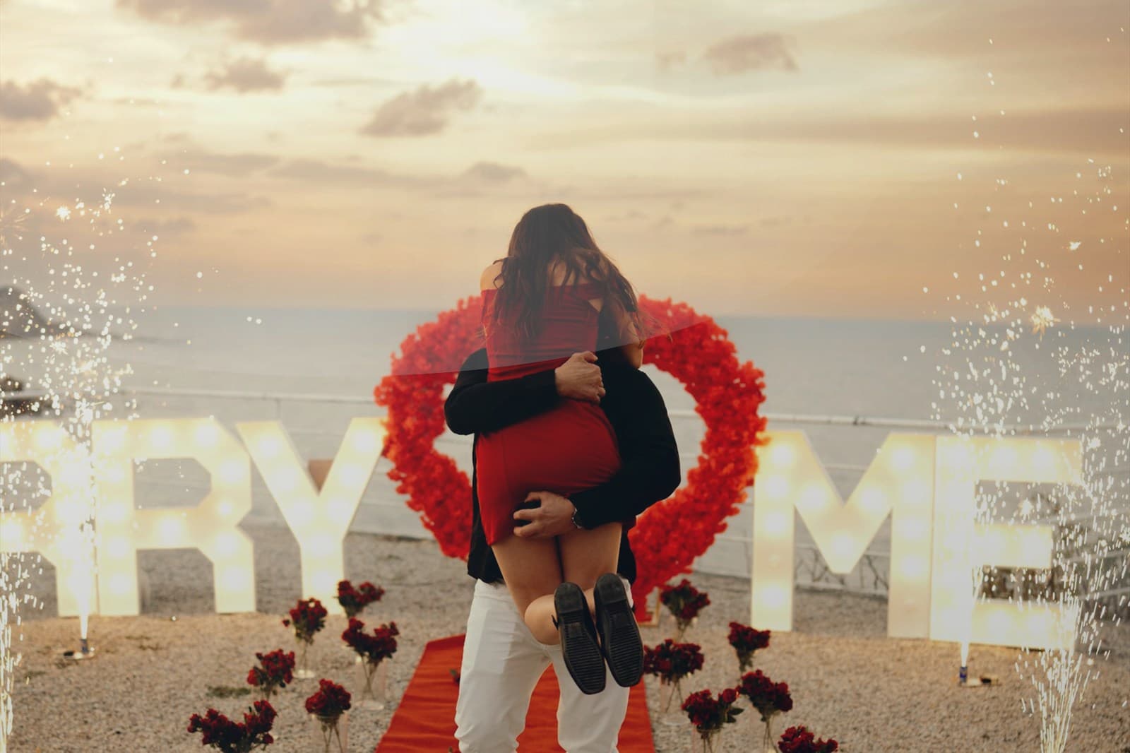 Aerial view of a tropical island shoreline lined with palm trees.