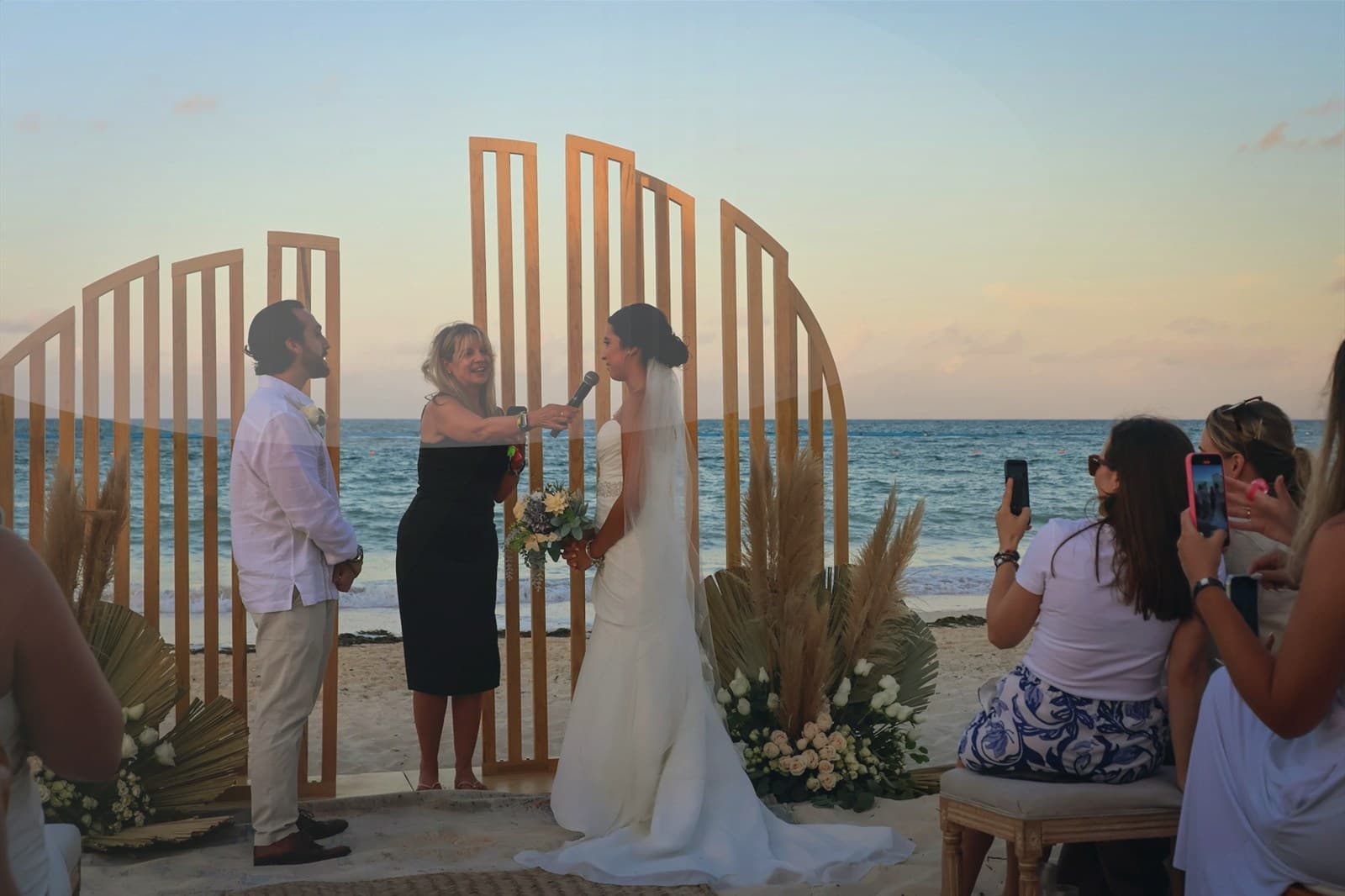 Aerial view of bright turquoise water and a tropical beach.