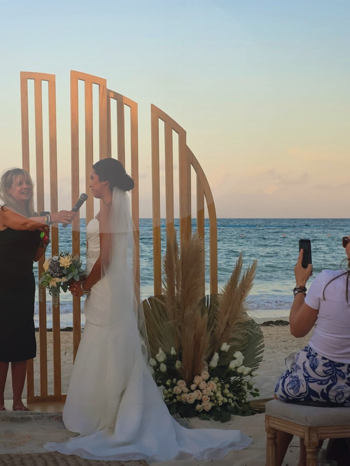 Couple kissing on the beach at sunset.