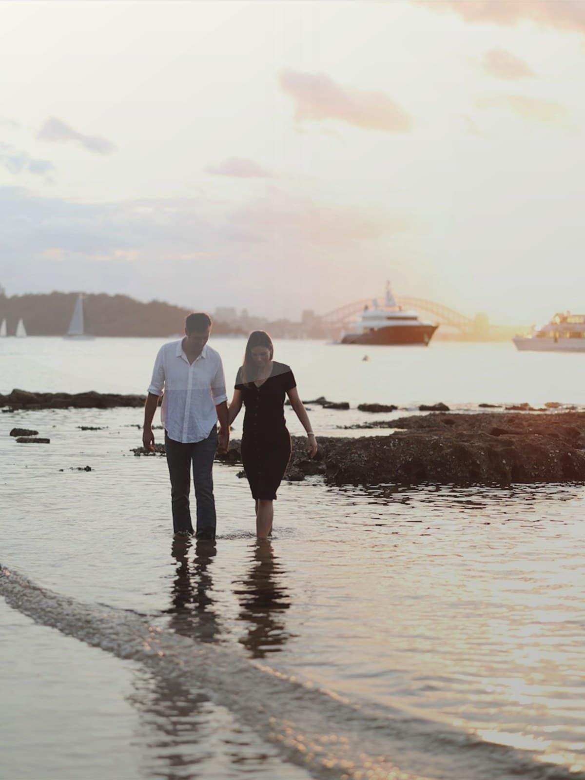 Couple embracing on a beach at sunset.