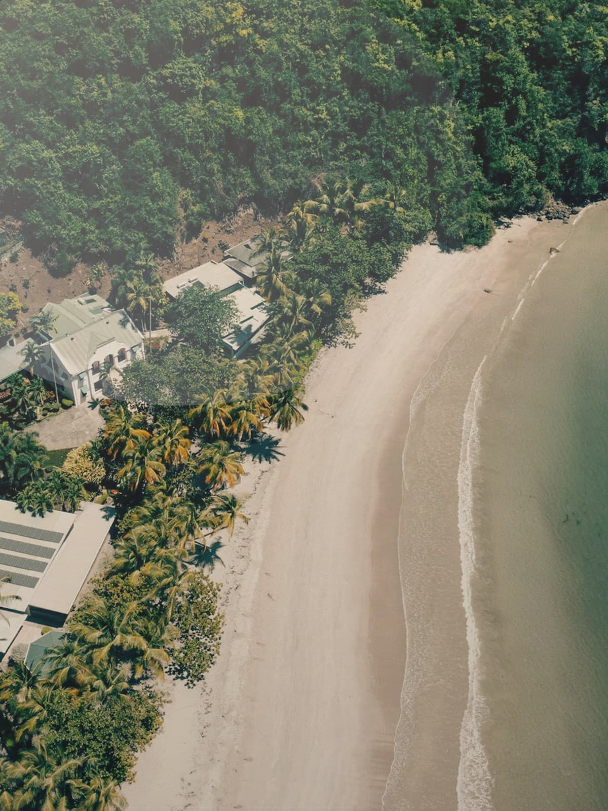 Man kneeling on the beach during a proposal at sunset.