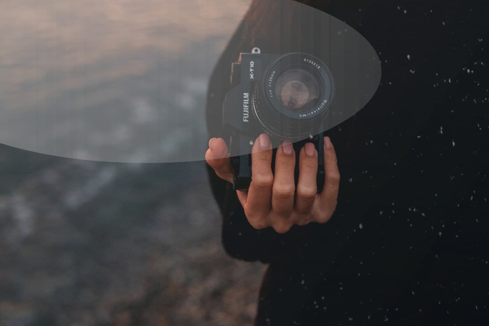 Parents holding a child's hands while walking on the beach.