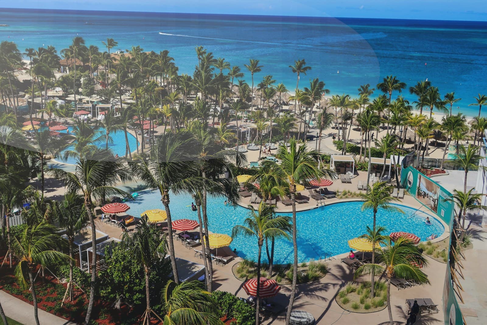 Family walking together near the shoreline at sunset.