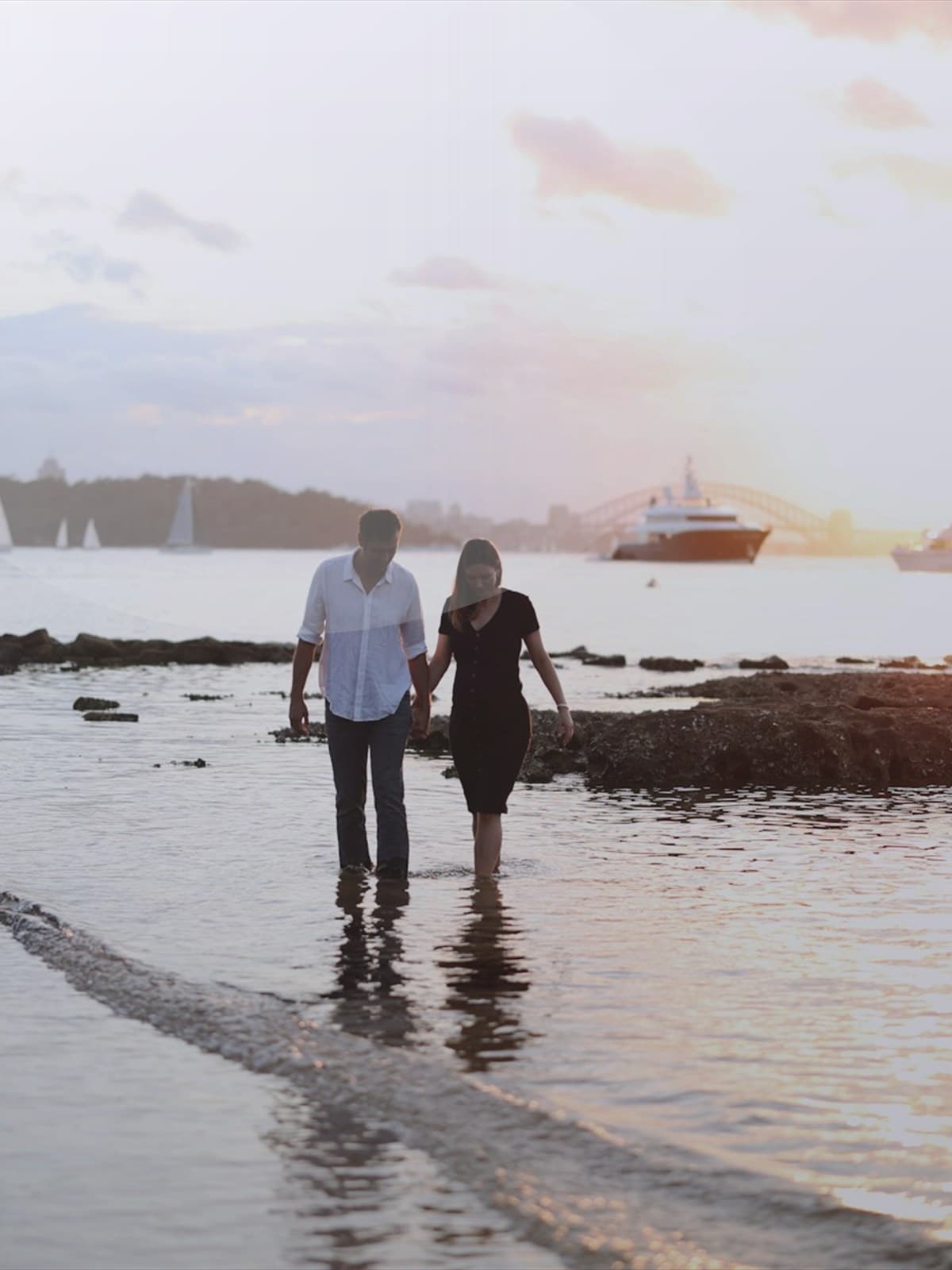 Pregnant woman silhouetted on the beach at sunset.